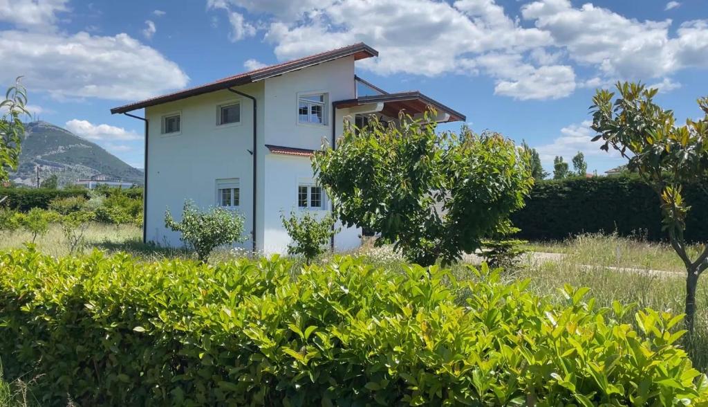 a white house in the middle of a field at DreamStay Lezha - Villa in Shëngjin