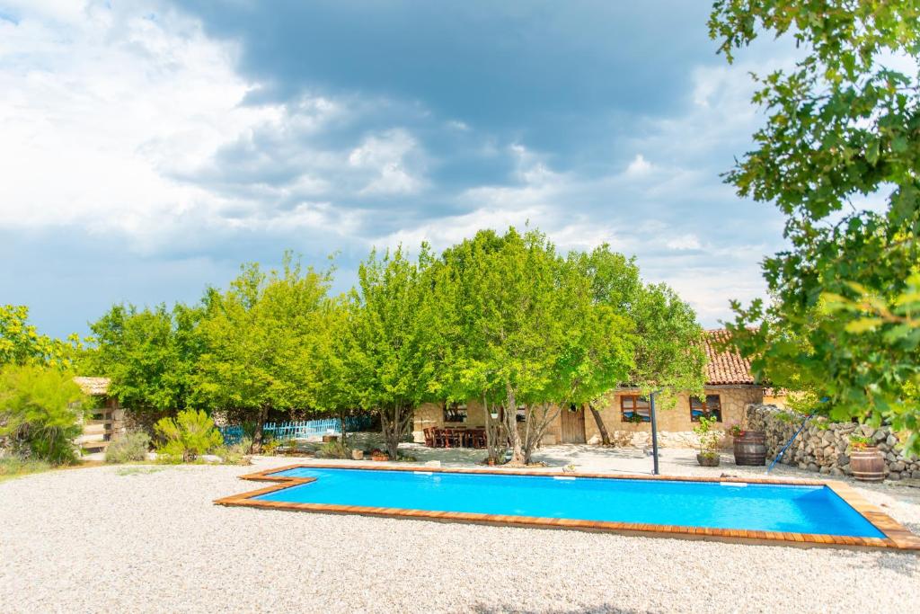 a swimming pool in a yard with trees at Etno vila Međugorje in Čapljina