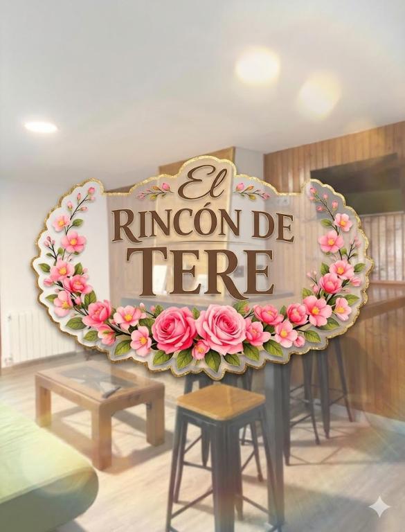 a sign in a room with pink flowers on it at El Rincón De Tere in Riaza