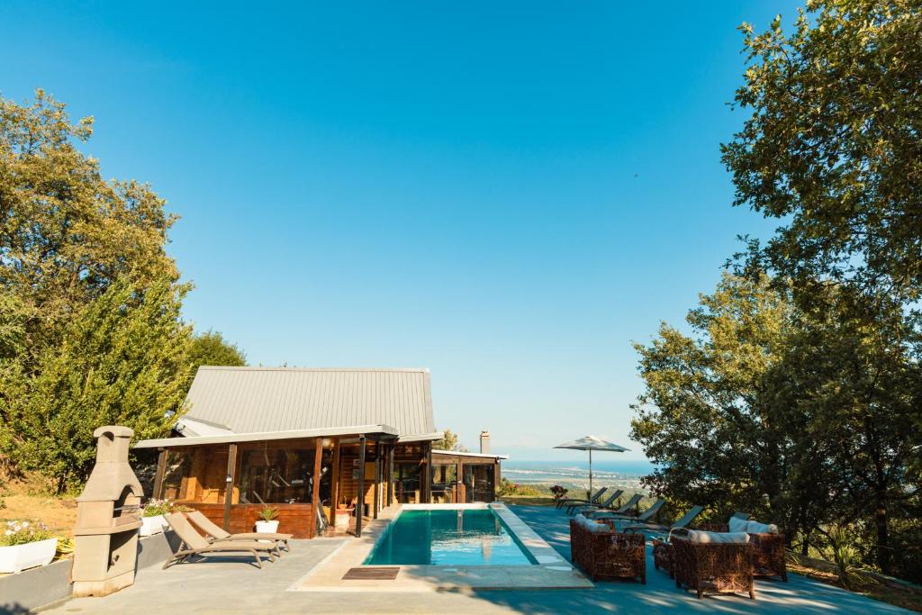 a house with a swimming pool next to a building at La VILLA DU REVE in Ulcinj