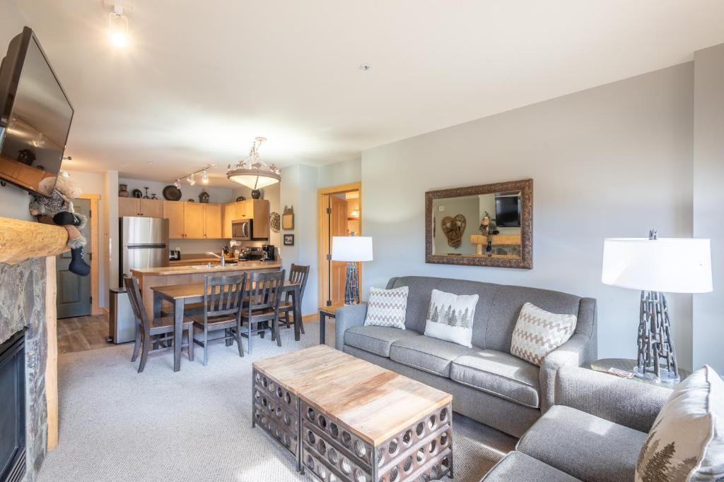 a living room with a couch and a table at Copper Springs Lodge 301 in Copper Mountain