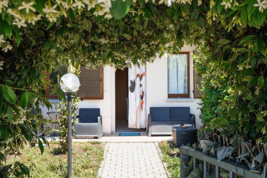 a house with two chairs and a porch with trees at Casa Stella Marina in Cervia