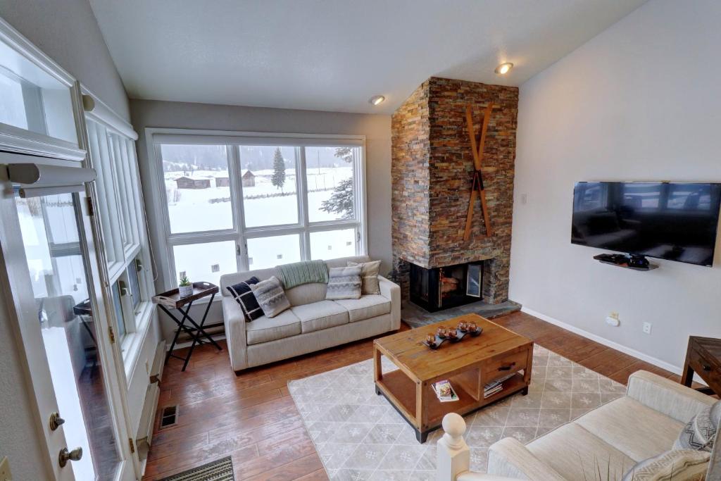 a living room with a couch and a fireplace at Woods12 Townhome Pet Friendly in Copper Mountain