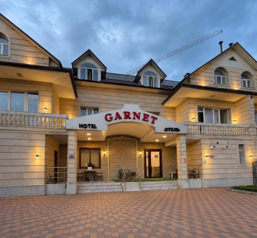 a building with a sign that reads game inn at Garnet hotel in Bishkek