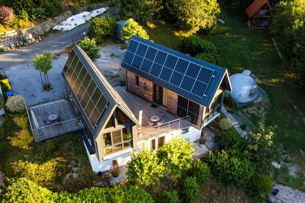 an overhead view of a house with a solar roof at Taunus Tinyhouse - Sauna, Grillplatz & Naturidylle in Weilrod