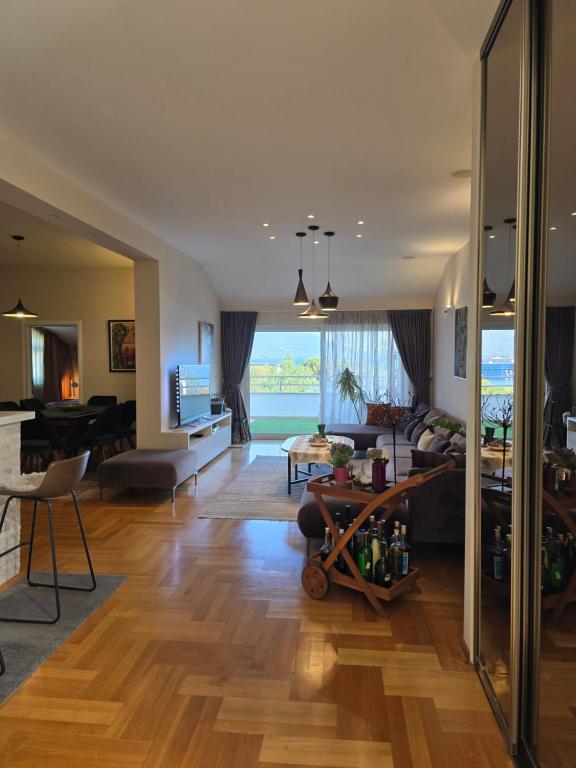 a living room with a couch and a table at Sea View Apartment in Bijela