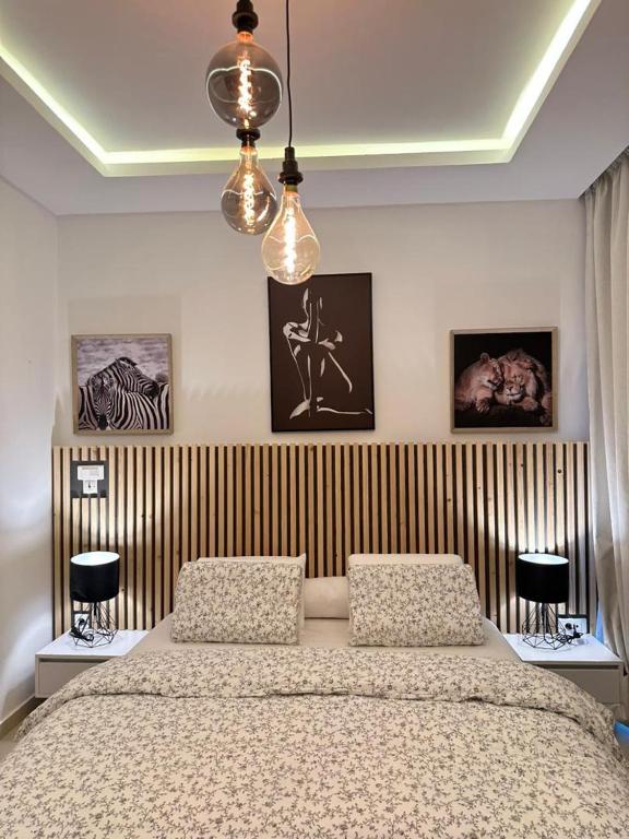 a bedroom with a large bed and two lamps at Antilia home 1 in Abidjan
