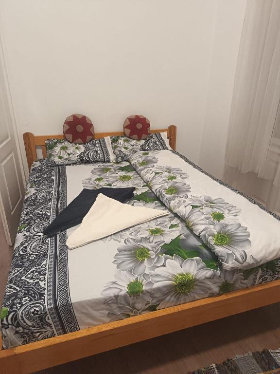 a bed with a floral comforter on it at Station Backpackers in Budapest