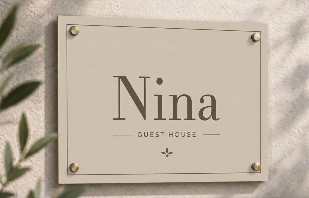 a sign that reads nima guest house on a wall at Nina Guest house in Gaeta