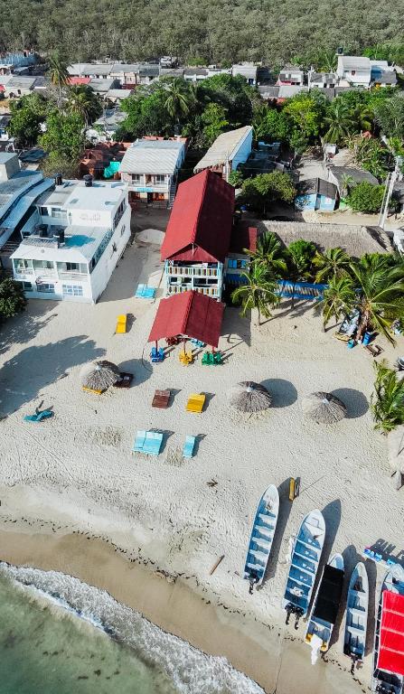 an aerial view of a beach with chairs and umbrellas at Mamallena Beachside Rincon del Mar in Rincón