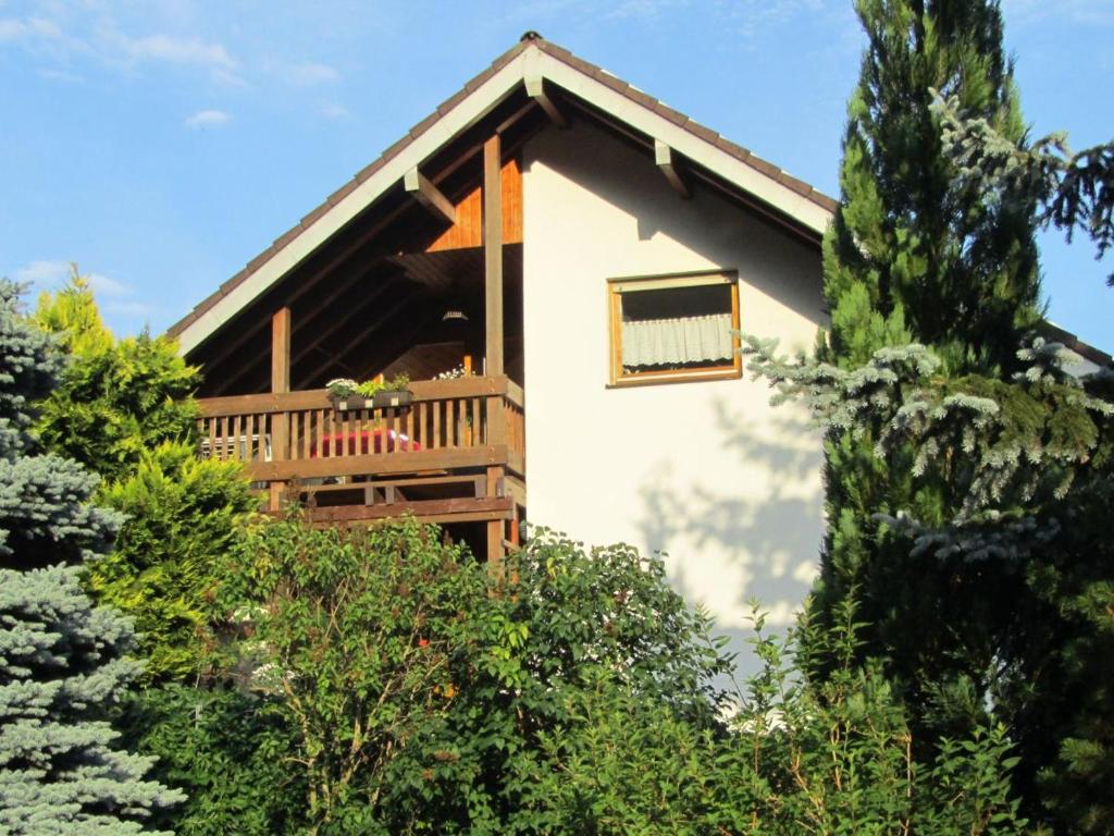 a house with a balcony and trees at Fewo Glaser in Lug