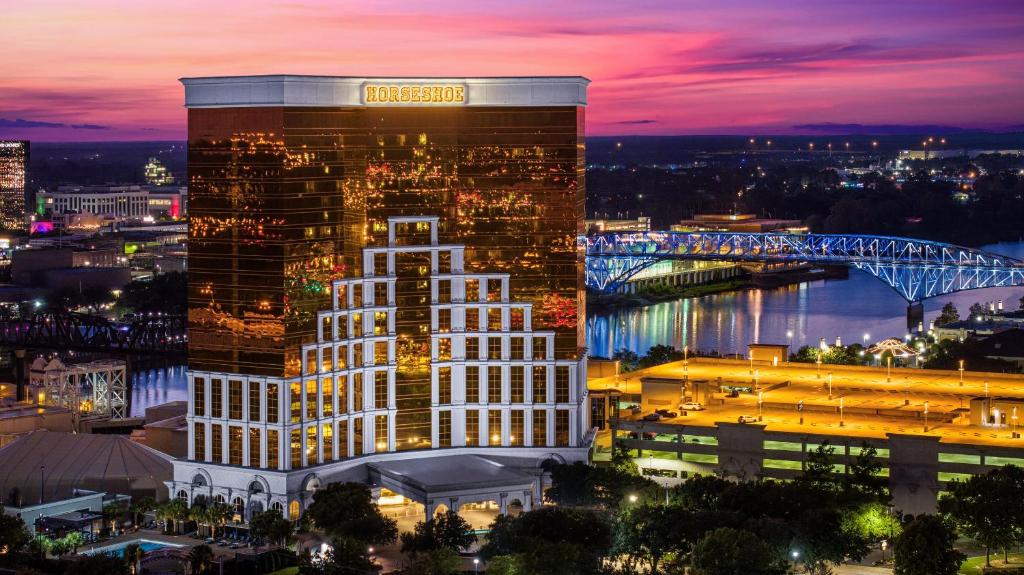 a tall building with a sign on it at night at Horseshoe Bossier City Hotel & Casino - A Caesars Rewards Destination in Bossier City