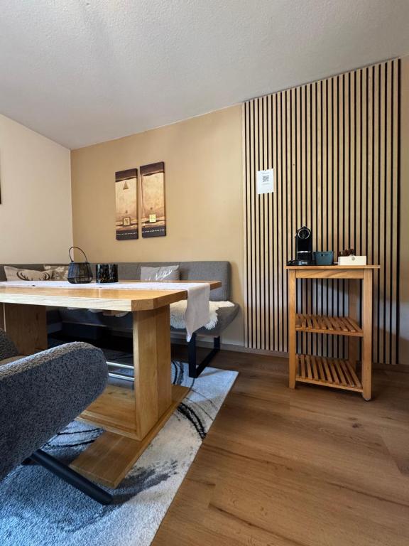 a living room with a table and a couch at Haus Asslaber in Hochfilzen