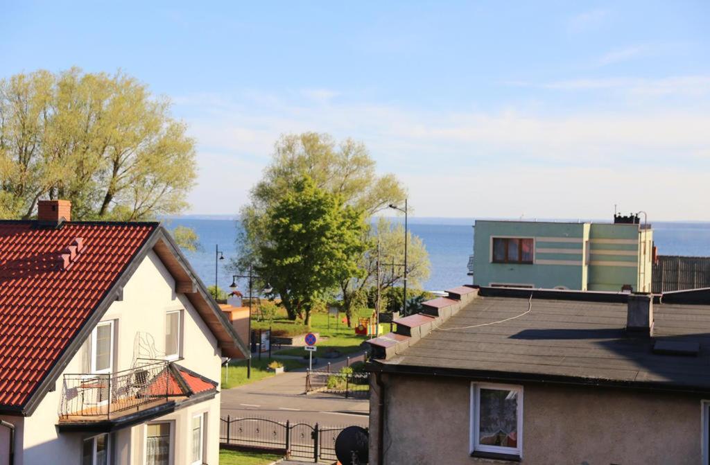 a view of roofs of houses and the ocean at Pokoje Iza in Chałupy