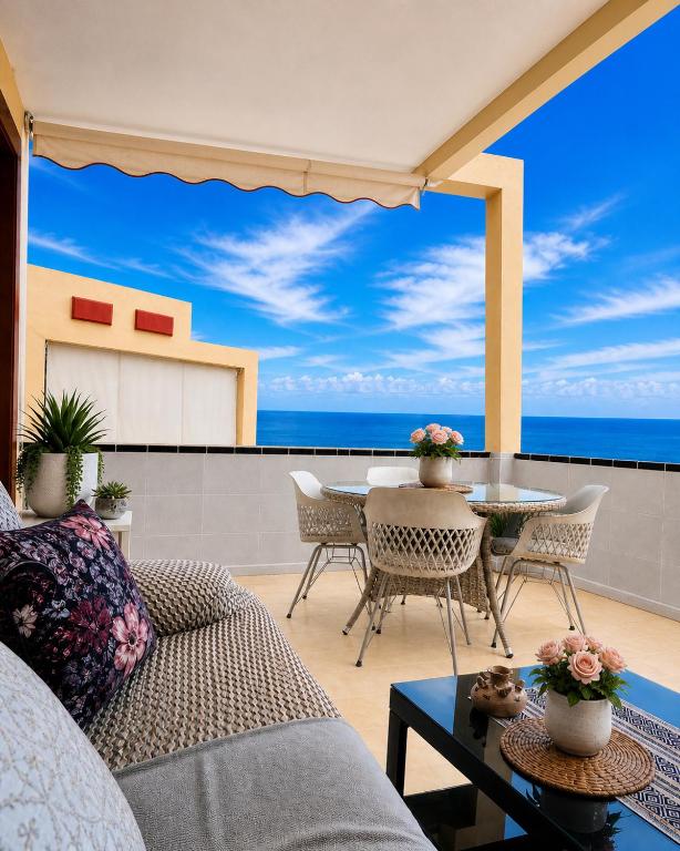 a living room with a view of the ocean at Best Ocean View & Sunset - Los Cristianos in Los Cristianos