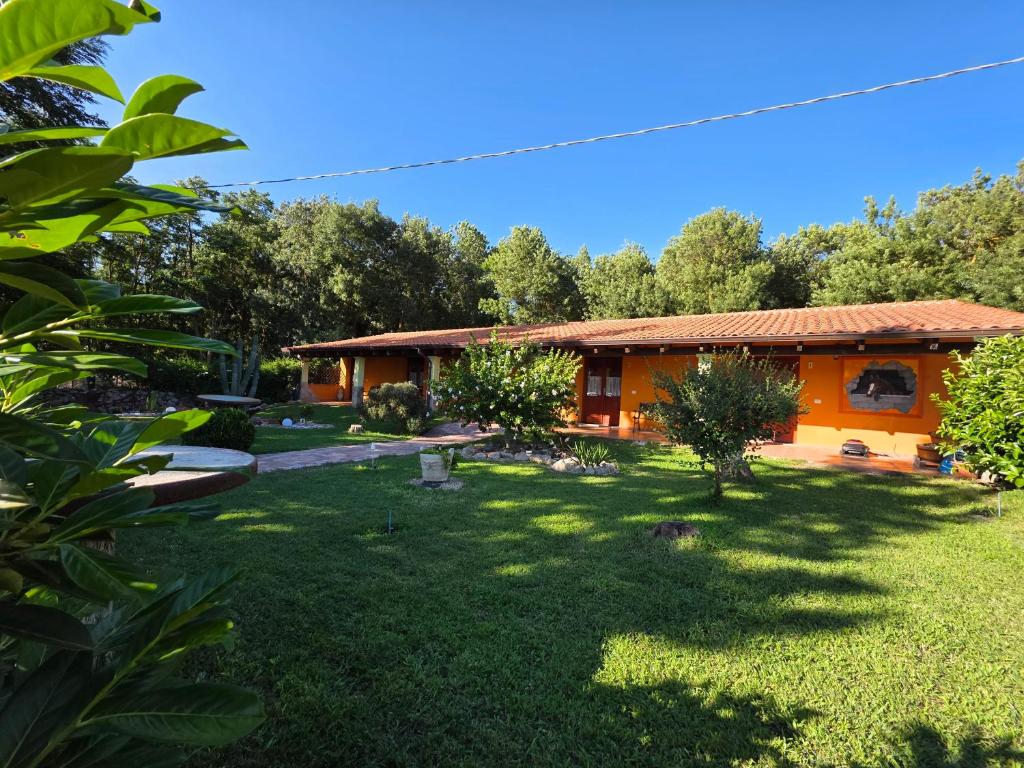 a house with a yard in front of it at Bungalow Coronas in Bonorva