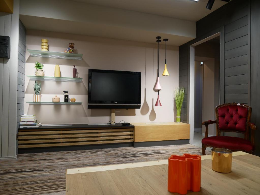 a living room with a flat screen tv on a wall at L Atelier Secret in Guebwiller