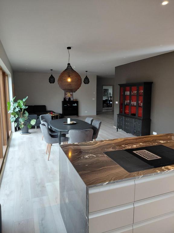 a kitchen and living room with a table and chairs at Elliðaár Valley Guesthouse in Reykjavík