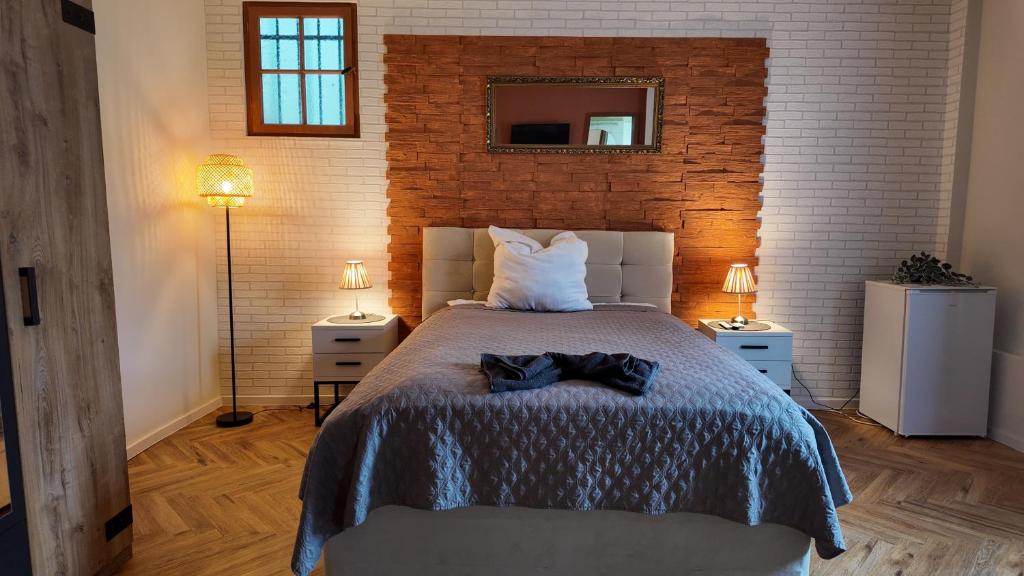 a bedroom with a large bed with two night stands at EVIA Hotel restaurant in Recklinghausen