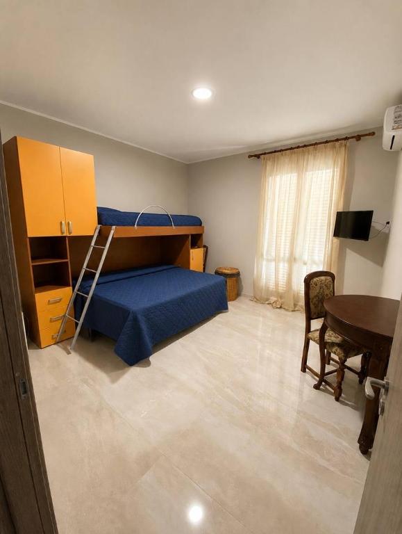 a bedroom with a bunk bed and a desk at Trinacria in Montevago