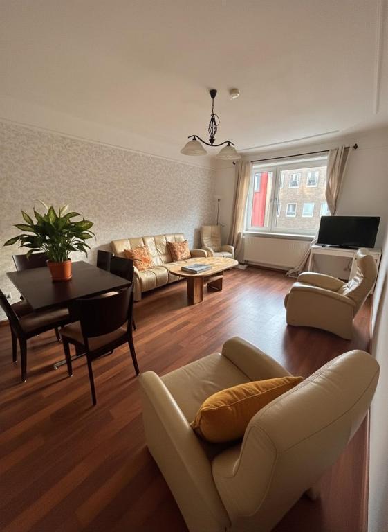 a living room with a couch and a table at Midtown Apartment Hannover in Hannover