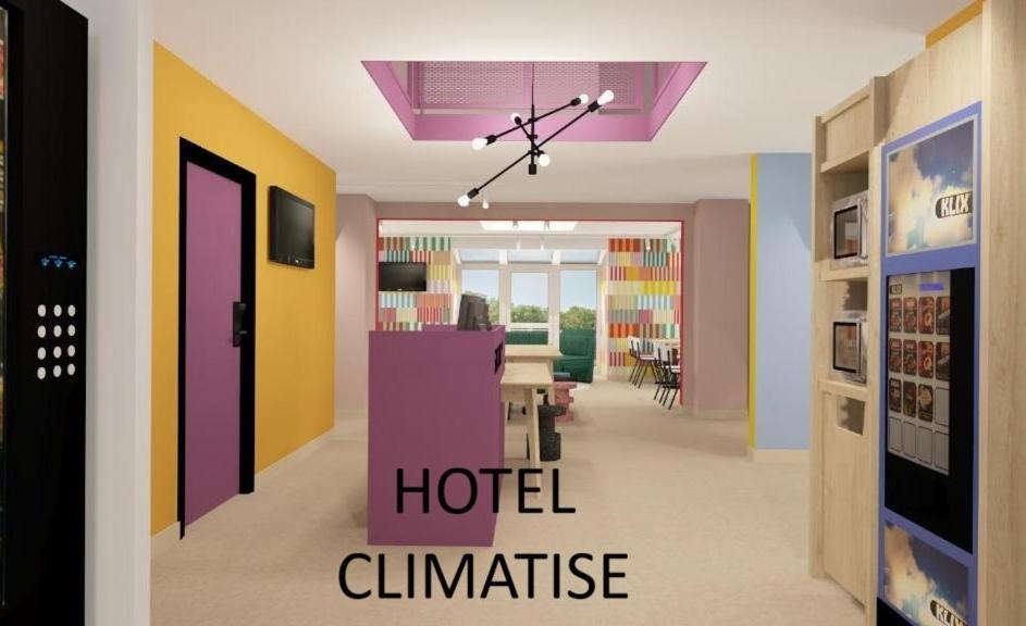 a room with colorful walls and a hotel entrance at Unisotel Lyon Bron Eurexpo in Bron