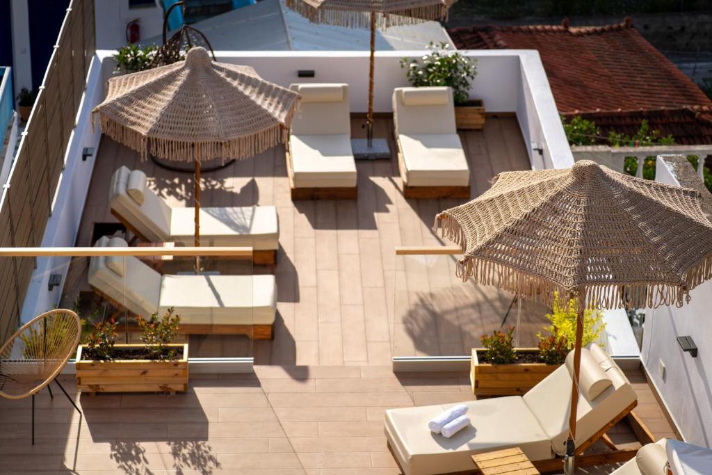 an overhead view of a patio with chairs and umbrellas at Galini Hellenic Hospitality in Patitiri
