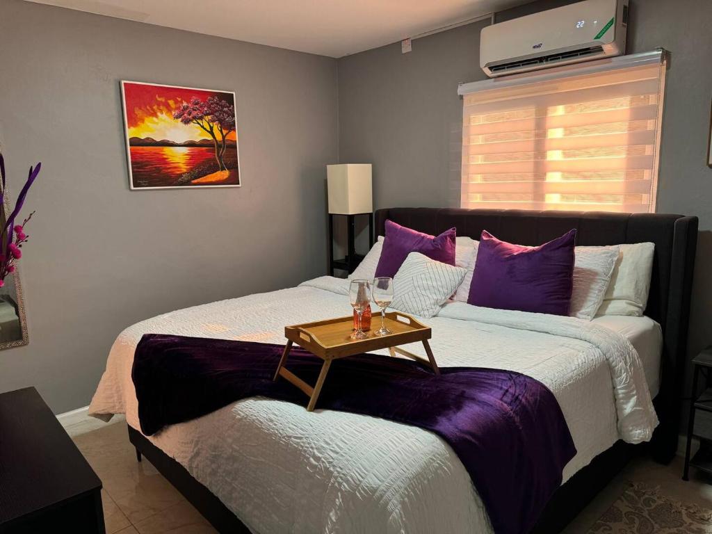 a bedroom with a bed with a table on it at Elegant 3-Bedroom Loft Condo in Kingston