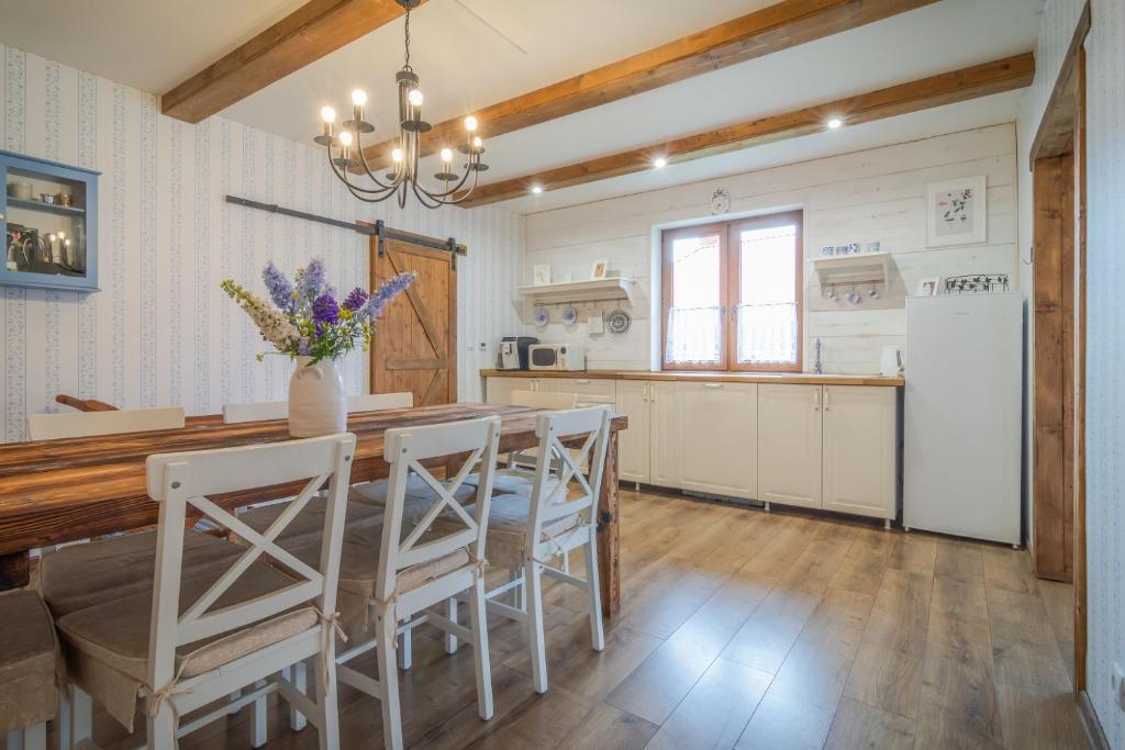 a kitchen with a table and chairs and a refrigerator at Modrý Dom - Telgárt Resort in Telgárt