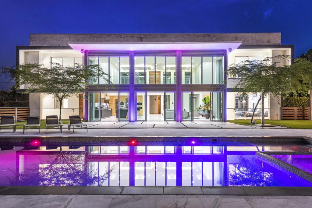 a house with a swimming pool in front of it at Luxury 9-Bedroom Villa in Southwest Ranches with Private Pool, Jacuzzi, and Movie Theater, Sleeps 20 in Miami