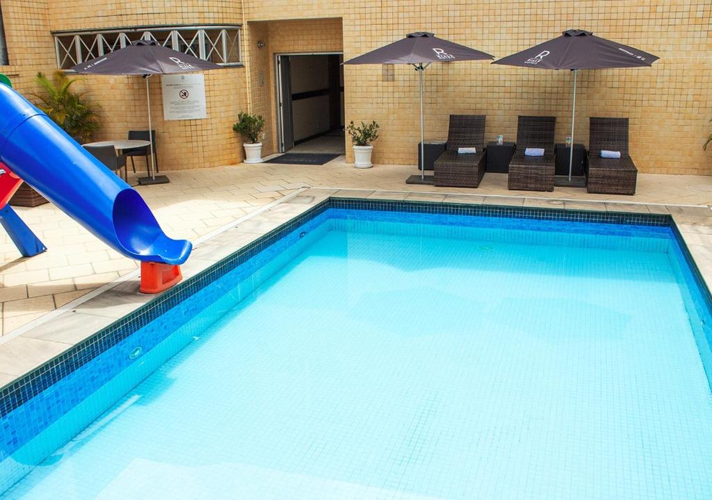a swimming pool with a slide in a hotel at Riale Imperial Flamengo in Rio de Janeiro