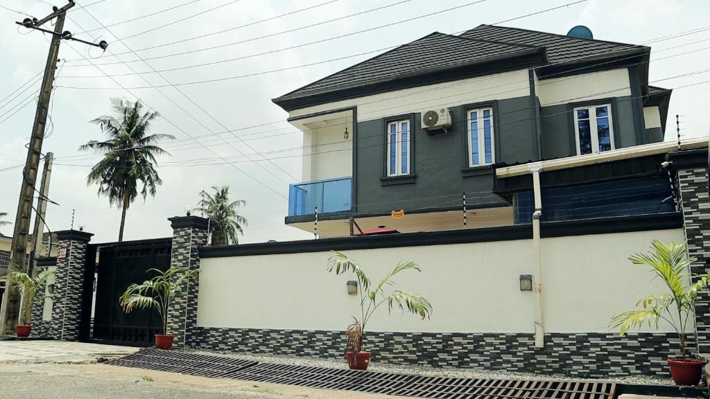 a house with a black and white garage at JRC Chariot Luxury Apartment in Omole