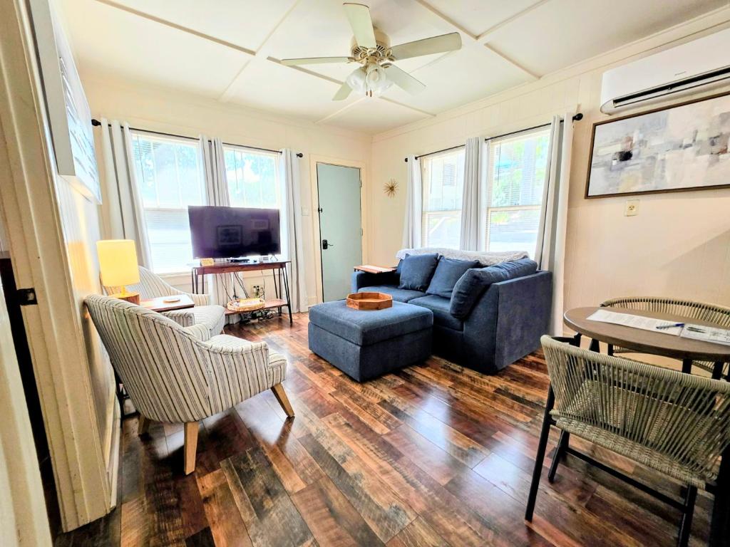 a living room with a couch and a tv at #05 - Lakefront Two Bedroom Cottage- Pet Friendly in Hot Springs