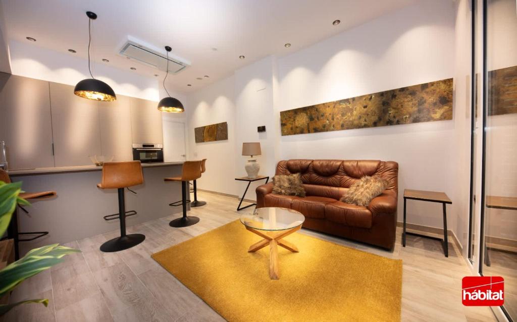 a living room with a couch and a table at Domus Halo D in Pamplona