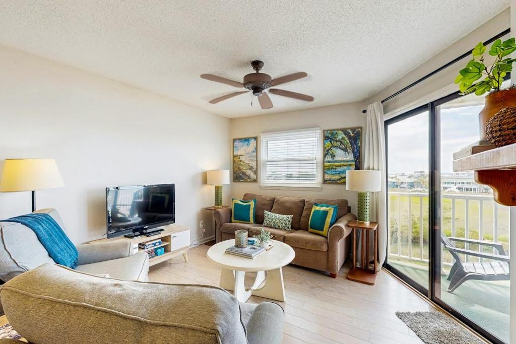 a living room with a couch and a tv at Bay Creek Villa - 311 in Edisto Beach