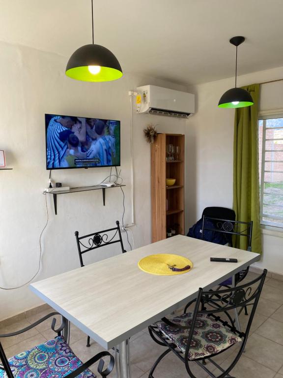 a dining room with a white table and chairs at Casa en la Punta San luis in La Punta