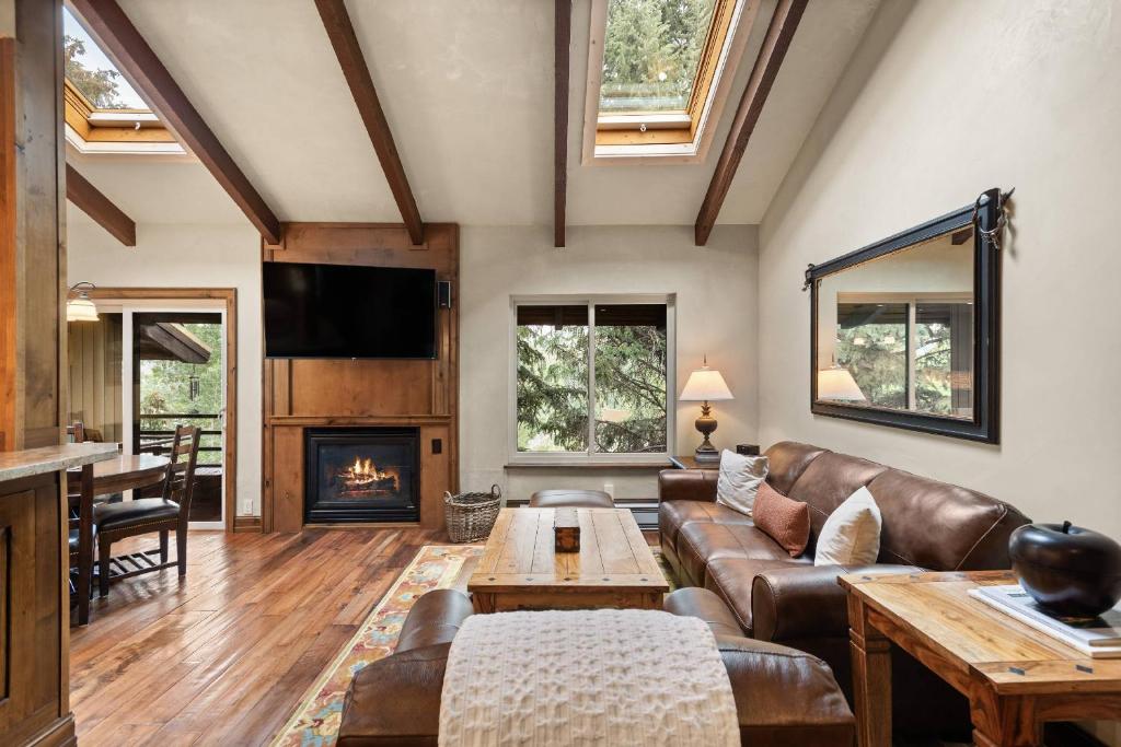 a living room with a couch and a fireplace at Seasons Four #178 in Snowmass Village