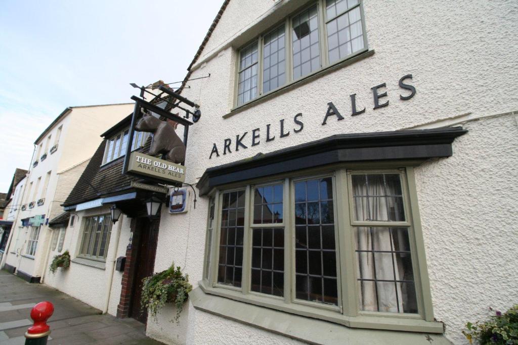 a white building with aaksleys ales sign on it at The Old Bear Inn in Cricklade