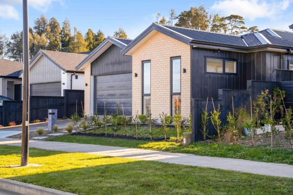 a house in a subdivision with a fence at Cosy Pukekohe Self-Contained Unit with Kitchenette in Pukekohe East