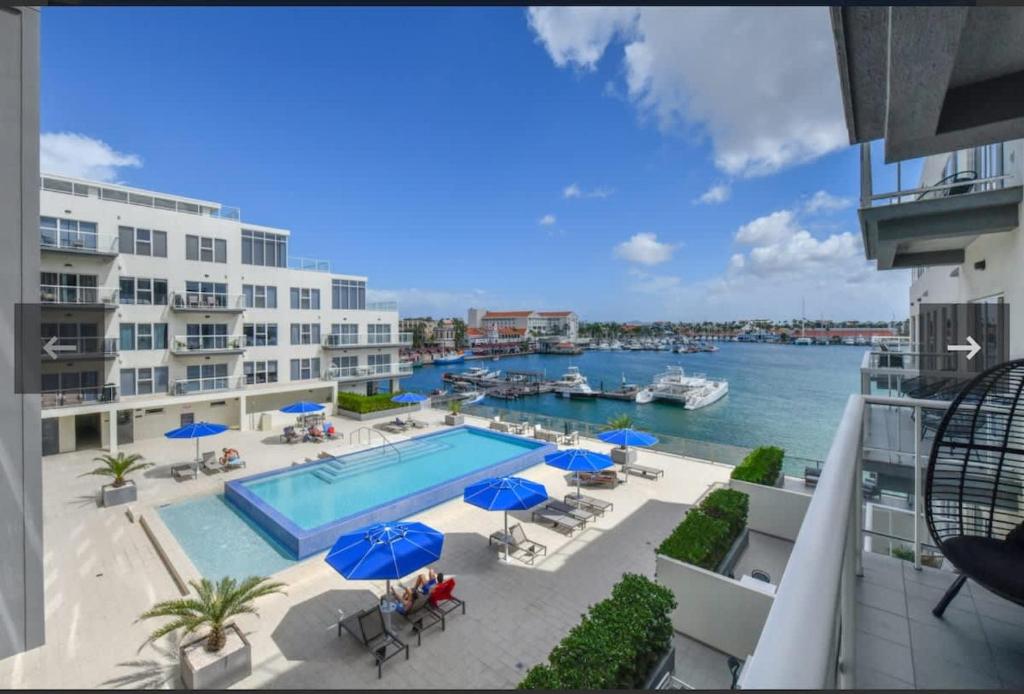 a view of a pool from a balcony of a apartment at Harbour House apt 410 in Oranjestad