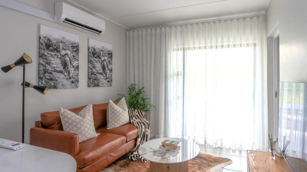 a living room with a couch and a table at Ballito Hill's Serenity Suite in Ballito