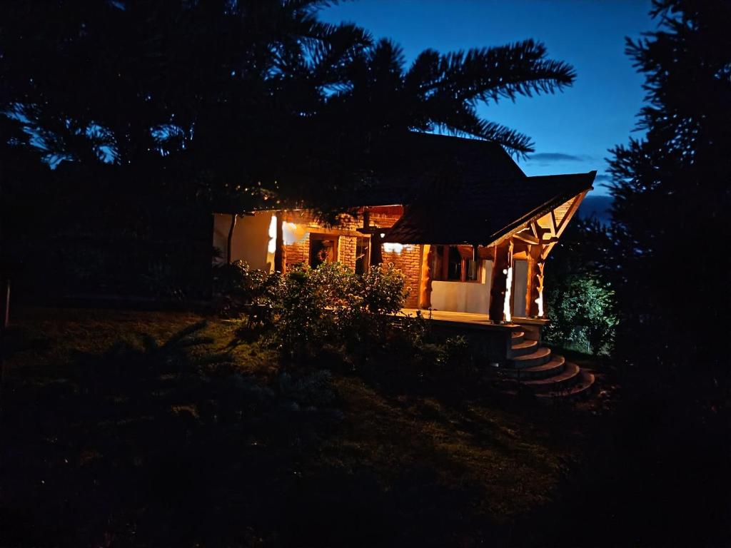 a small house lit up at night at Rustic Dreams-Dobolii de Sus in Dobolii de Sus