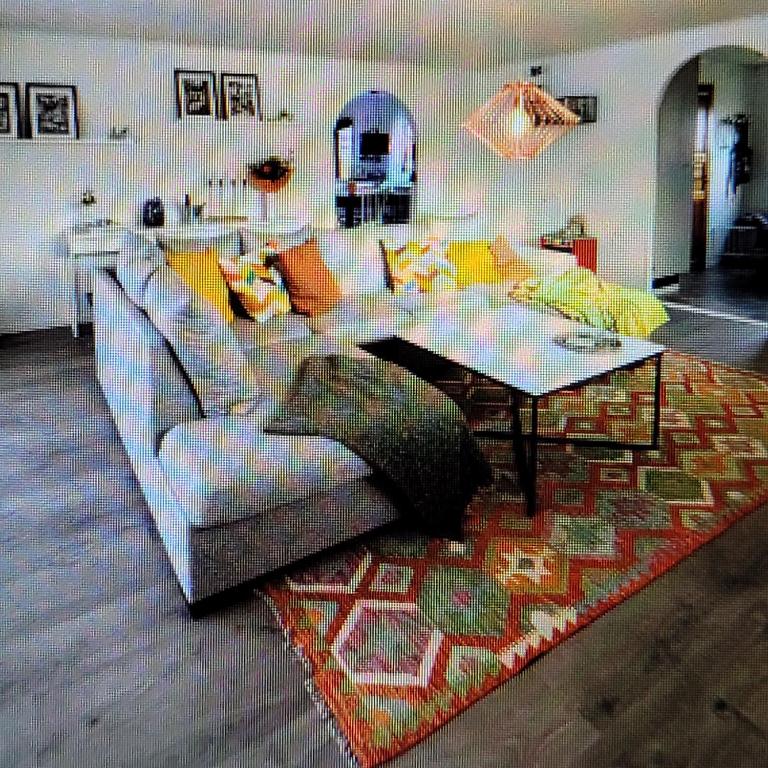 a living room with a couch and a table at Bright, fully equipped property in Örebro in Örebro