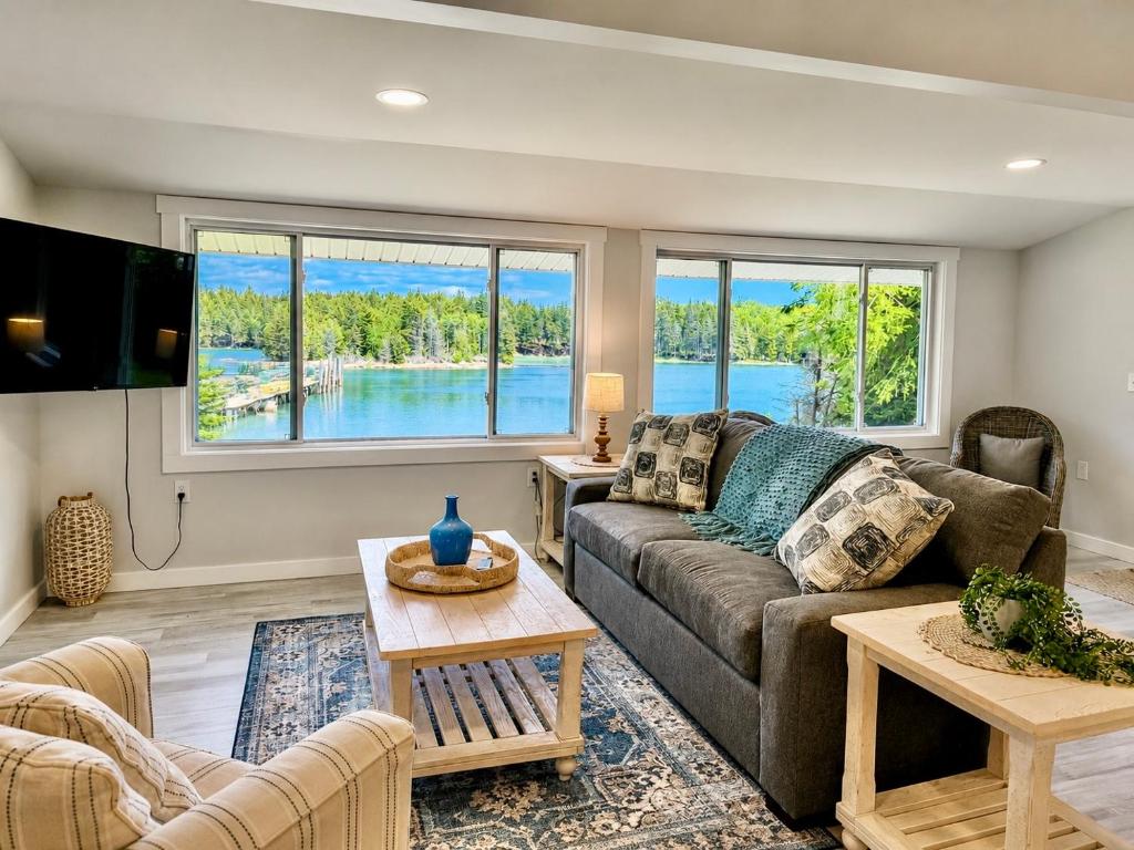 a living room with a couch and a table at Oceanfront Cottage on Private Island in Milbridge