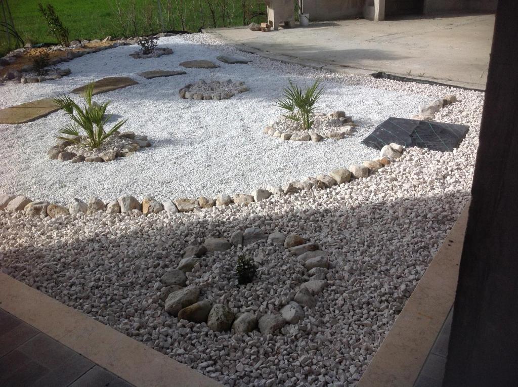 a garden with rocks and plants in a yard at Pisceneris Holiday Home in Uras