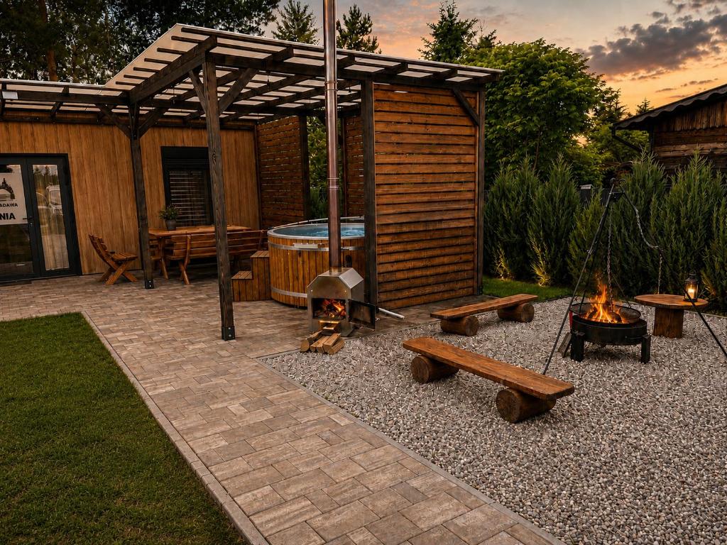 a backyard with a fire pit and a wooden cabin at H&Z Radawa Zosia in Radawa