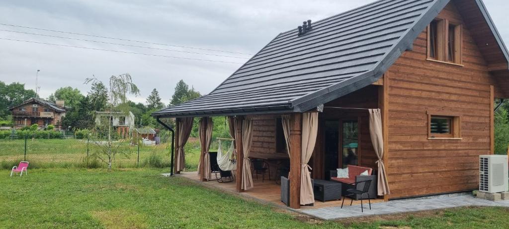 a log cabin with a gambrel roof at Bacówka pod Ślężą in Sulistrowice