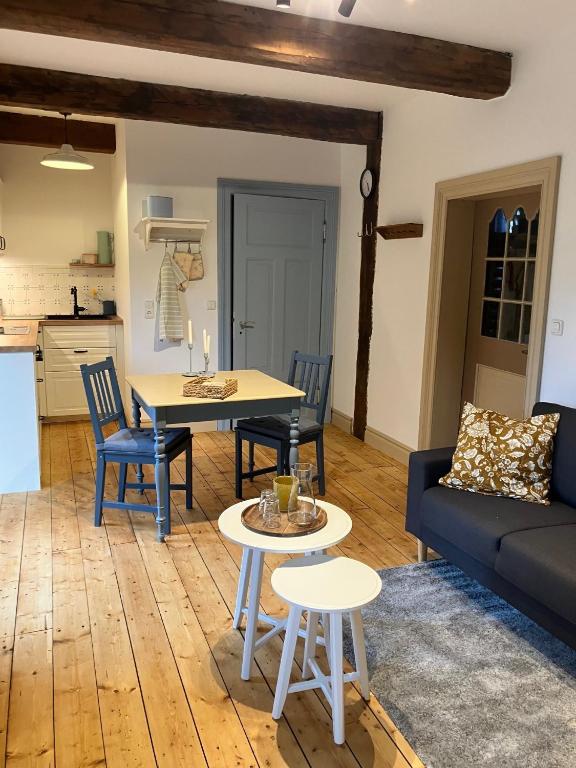 a living room with a table and a couch at Reetglück in Haseldorf