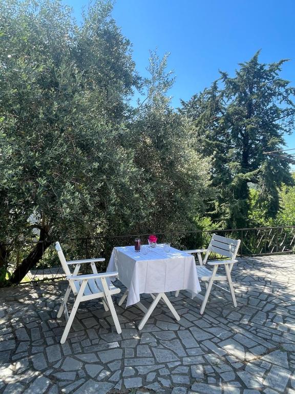 a table and two chairs sitting on a patio at Holiday House Bribir in Bribir