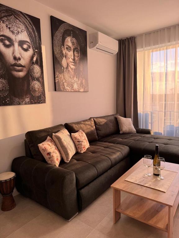 a living room with a brown couch and a table at Panoráma apartman in Dolný Čepen